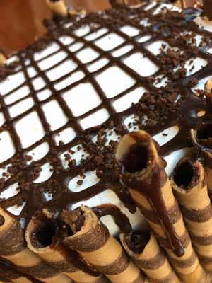 Our Chocolate Mocha ice cream cake is completely surrounded by chopped mocha sticks that are drizzled with chocolate fudge. We layer the fudge along the top of the cake in a crisscrossing pattern and add chocolate cake crunch as a final touch.
