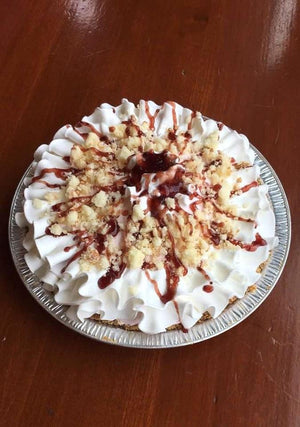 In this homemade graham crust you’ll find a taste of some sweet natural berries in our homemade Strawberry ice cream. Garnishing this pie are pound cake pieces and sweet drizzles of raspberries around a ruffle of vanilla whipped cream.