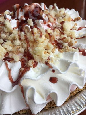 In this homemade graham crust you’ll find a taste of some sweet natural berries in our homemade Strawberry ice cream. Garnishing this pie are pound cake pieces and sweet drizzles of raspberries around a ruffle of vanilla whipped cream.